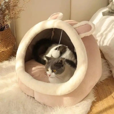 chat lové dans niche pour chat rose